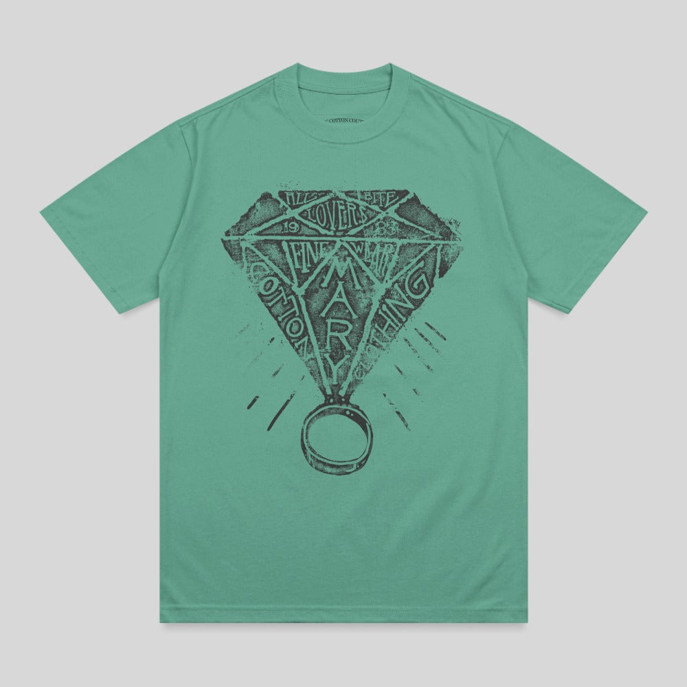 Green t-shirt with diamond ring graphic and text "COTTON MARLING".