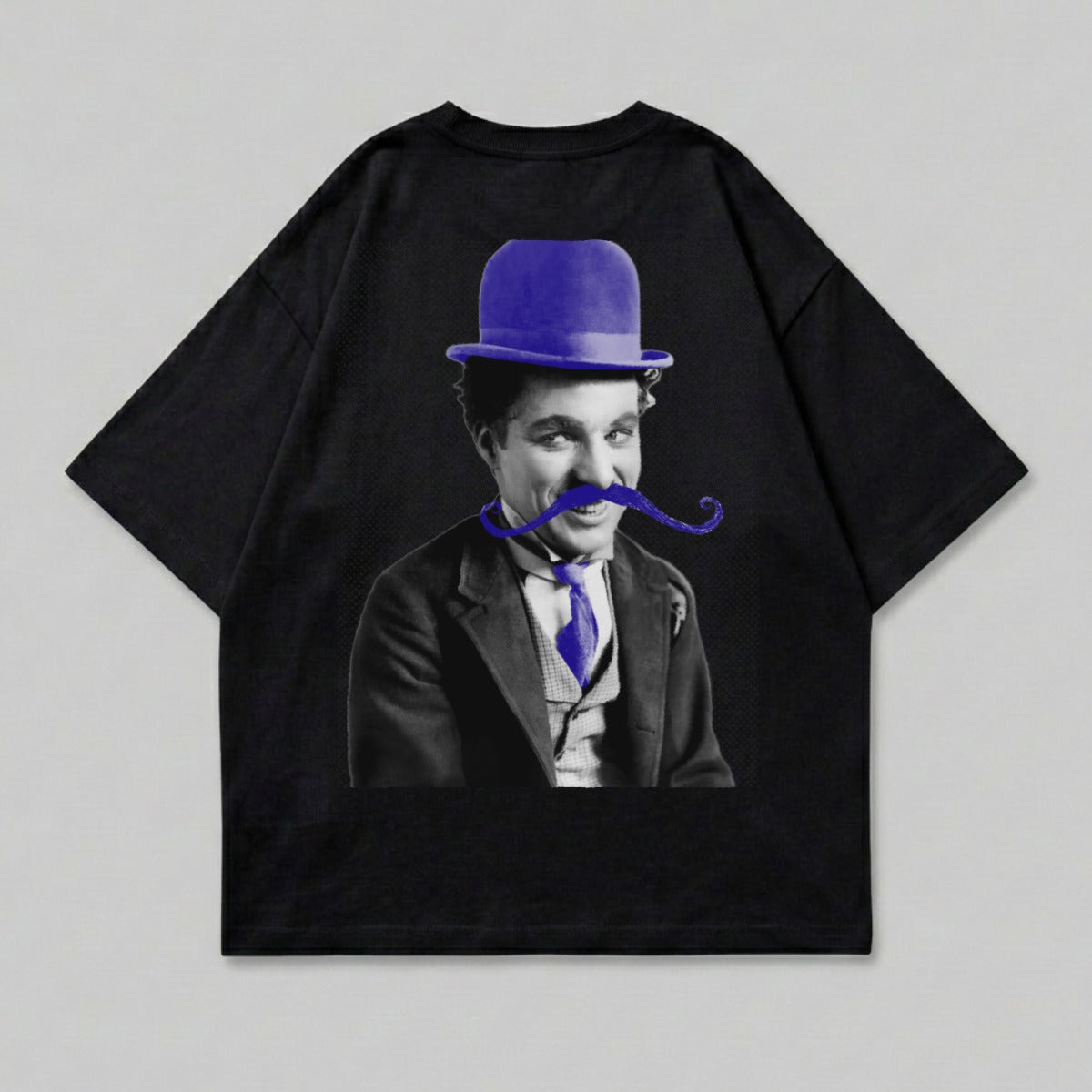 Charlie Chaplin wearing a blue bowler hat and mustache, printed on a black t-shirt.