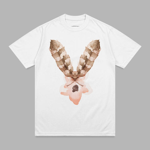White t-shirt with brown feather graphic and pink watercolor splash.