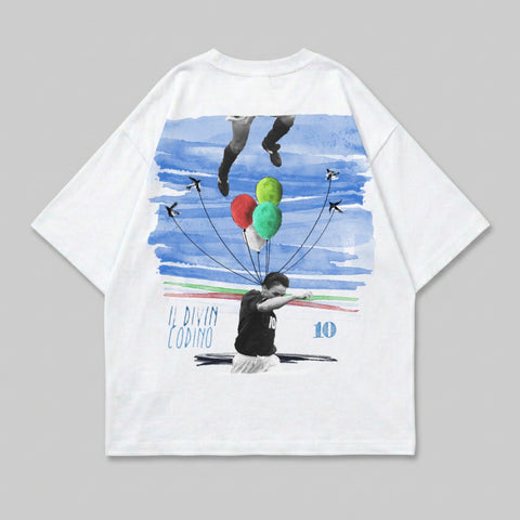 White t-shirt with distressed graphic of soccer player, balloons, and watercolor sky.