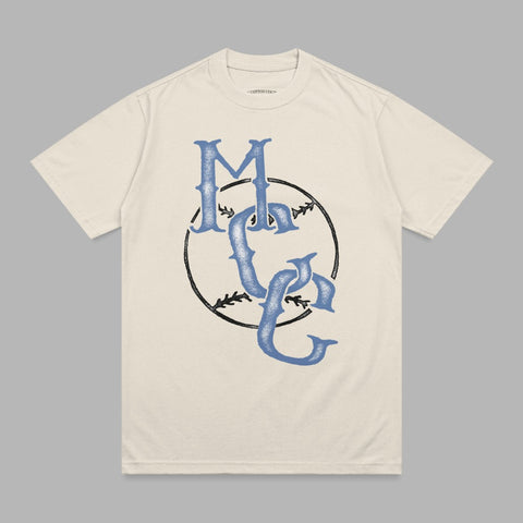 Cream t-shirt with blue "MC" logo in a baseball graphic.