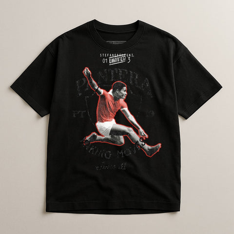 Black t-shirt with graphic of a jumping soccer player in red jersey.