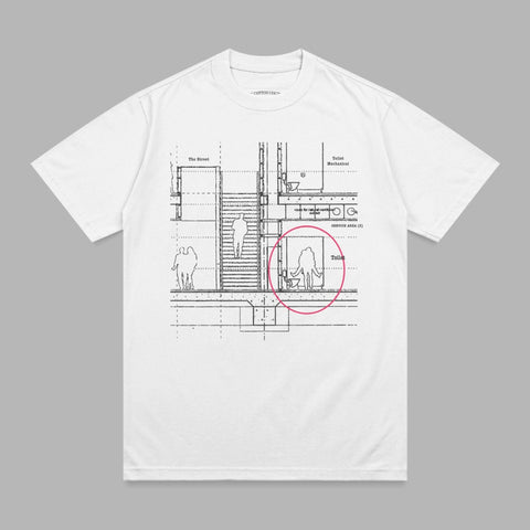 White t-shirt with a black line drawing of a building interior and people.