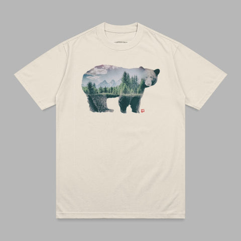Bear silhouette filled with a forest landscape and mountains.
