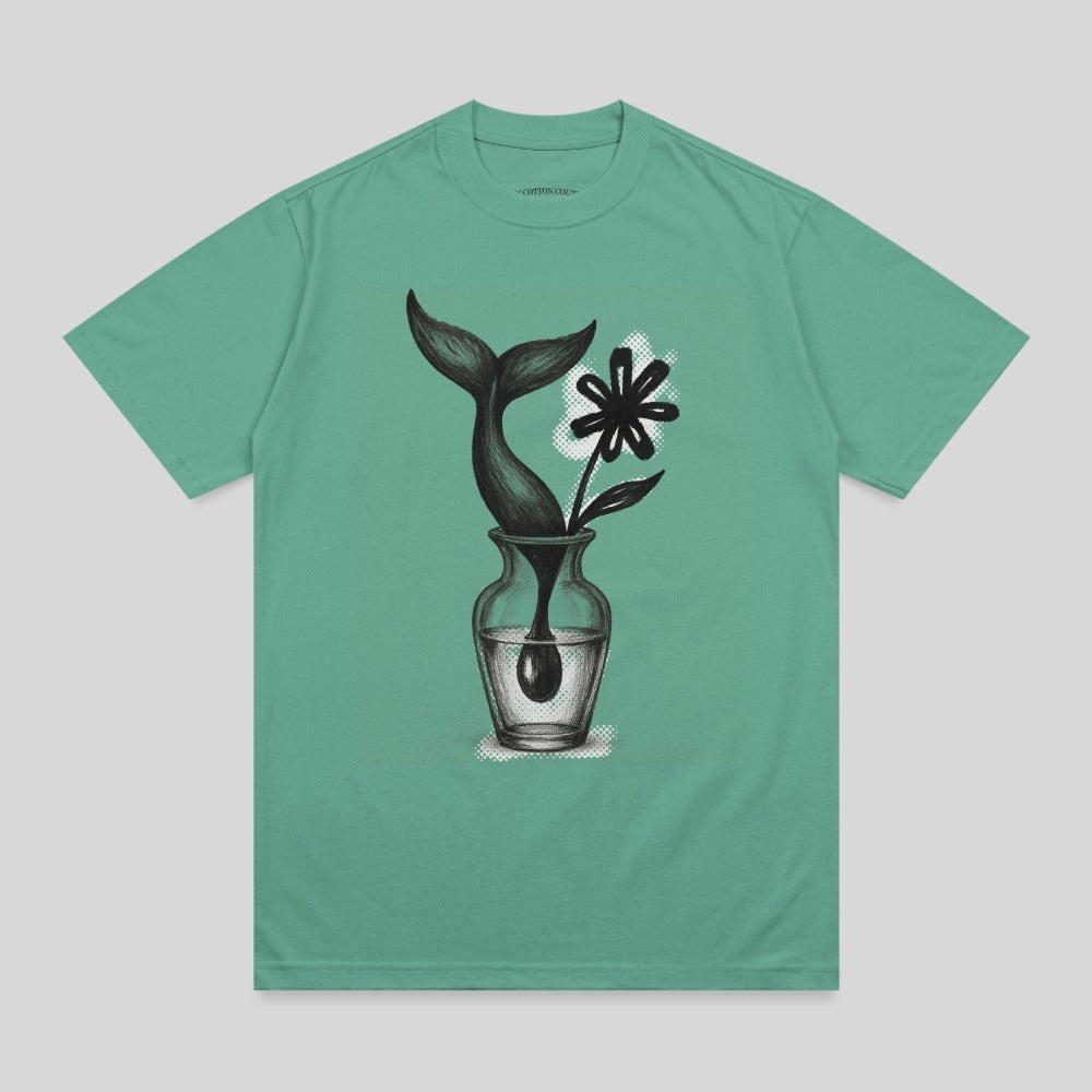 Teal t-shirt with drawing of a whale tail and flower in a vase.