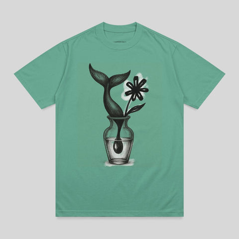 Teal t-shirt with drawing of a whale tail and flower in a vase.