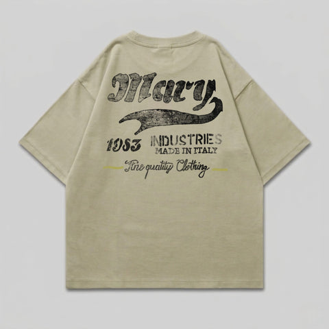 Tan t-shirt with "Mary 1953 INDUSTRIES MADE IN ITALY Fine quality Clothing" on the back.