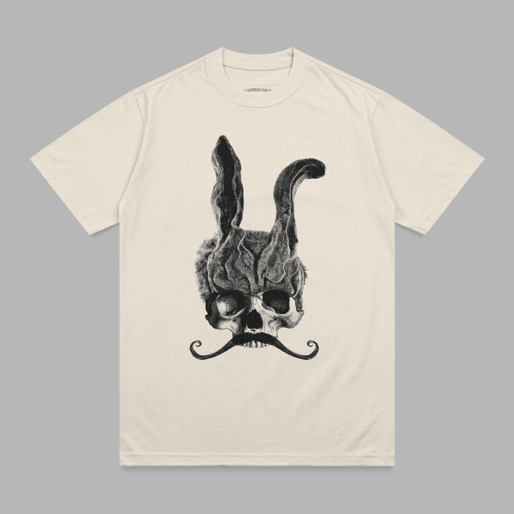 Cream t-shirt with a black graphic of a skull wearing a bunny mask and a mustache.
