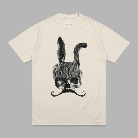 Cream t-shirt with a black graphic of a skull wearing a bunny mask and a mustache.