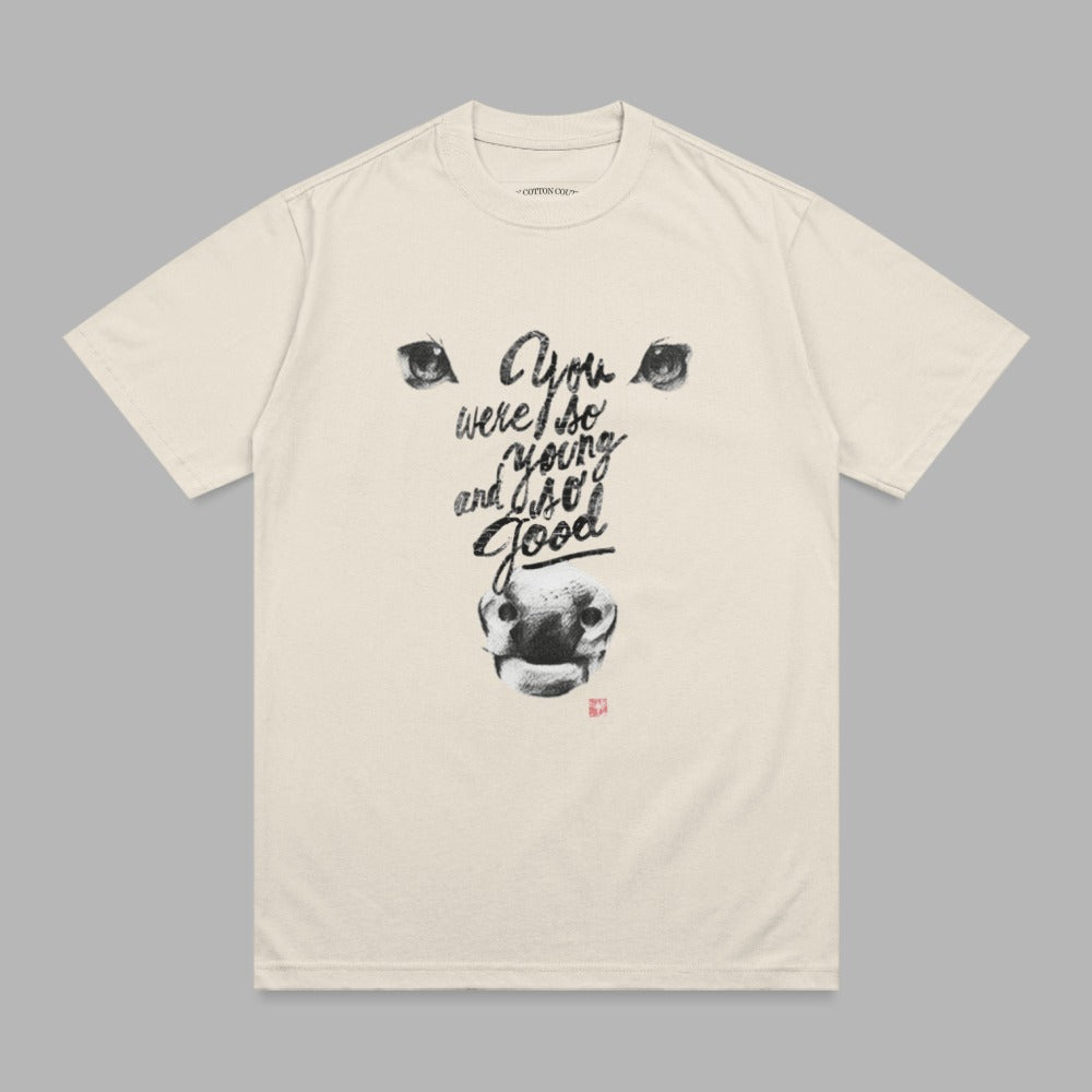 Cream t-shirt with black graphic of a bull's face and "You were so young and I so good" text.