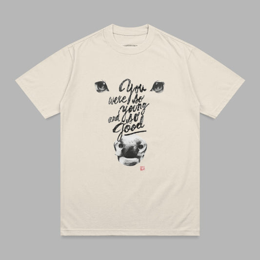 Cream t-shirt with black graphic of a bull's face and "You were so young and I so good" text.