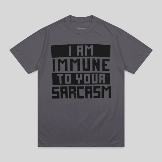Dark gray t-shirt with bold black text "I AM IMMUNE TO YOUR SARCASTIC".