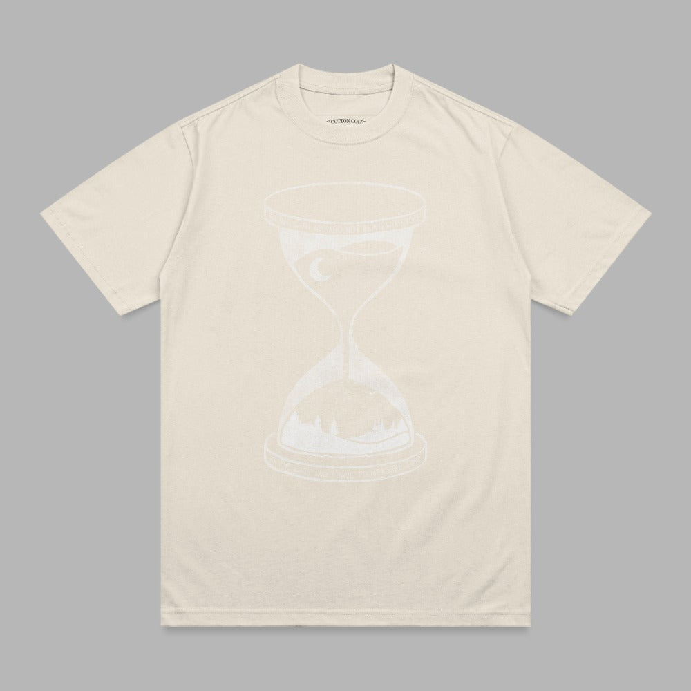 Cream t-shirt with white hourglass design showing a landscape and moon.