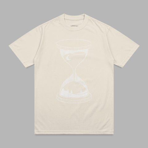 Cream t-shirt with white hourglass design showing a landscape and moon.