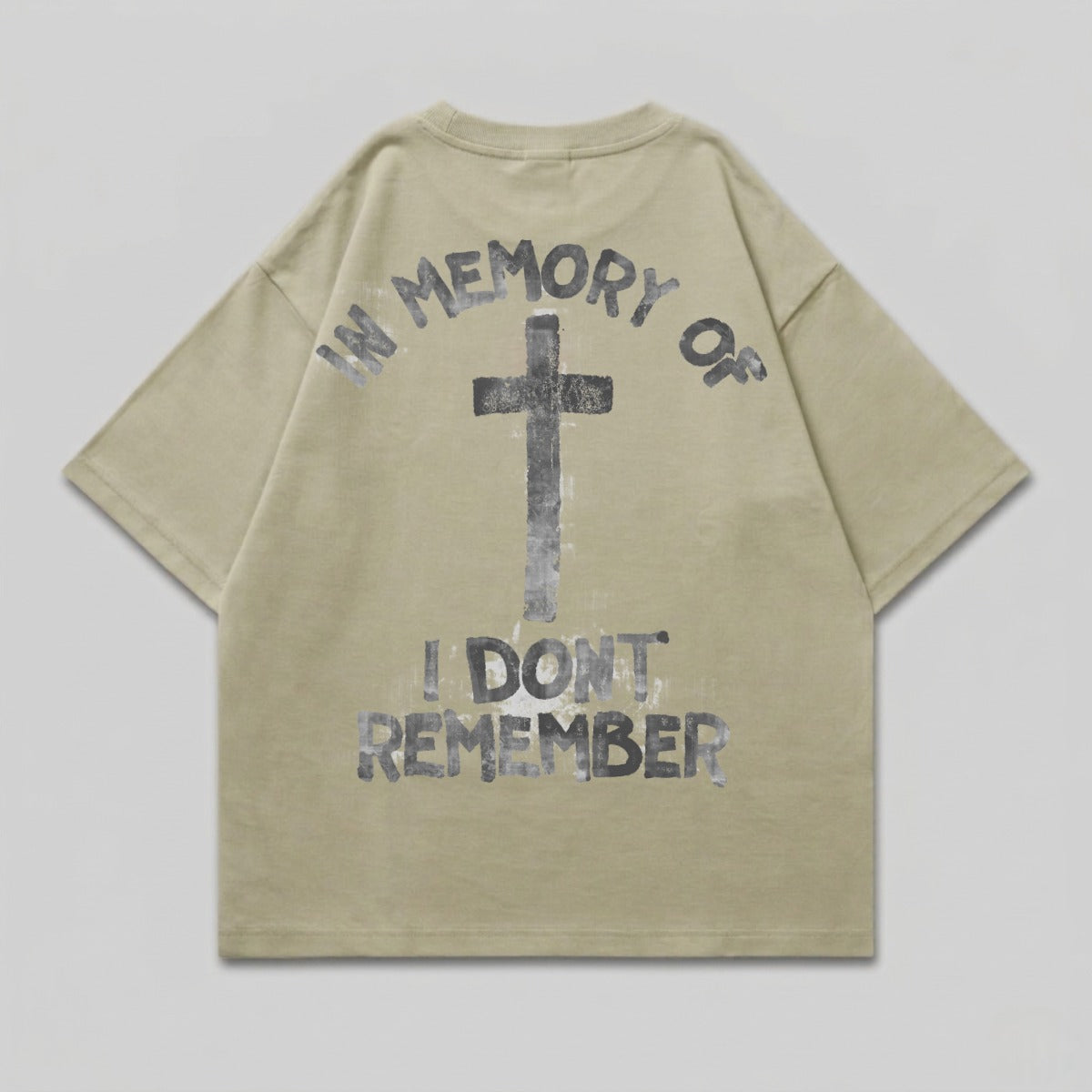 Khaki t-shirt with black cross and "IN MEMORY OF I DON'T REMEMBER" text.