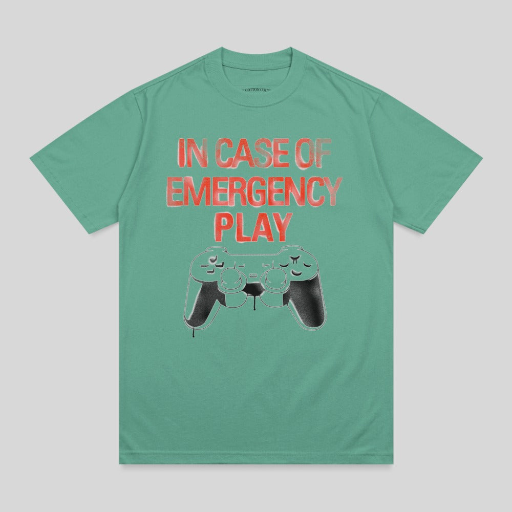 Green t-shirt with "IN CASE OF EMERGENCY PLAY" and game controller graphic.