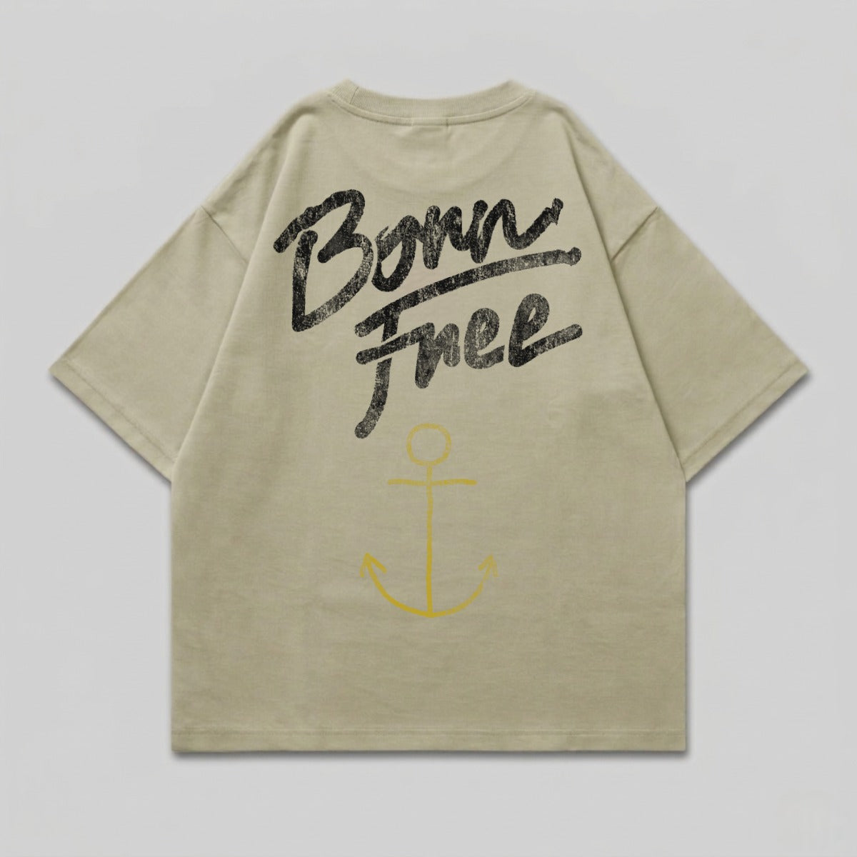 Light tan t-shirt with "Born Free" text and yellow anchor graphic on back.