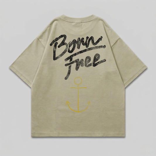 Light tan t-shirt with "Born Free" text and yellow anchor graphic on back.
