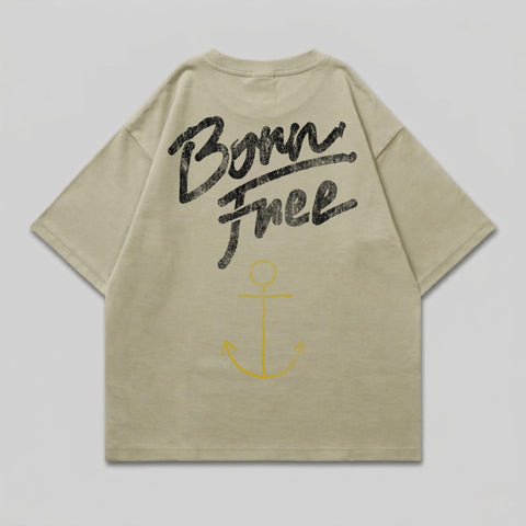 Light tan t-shirt with "Born Free" text and yellow anchor graphic on back.