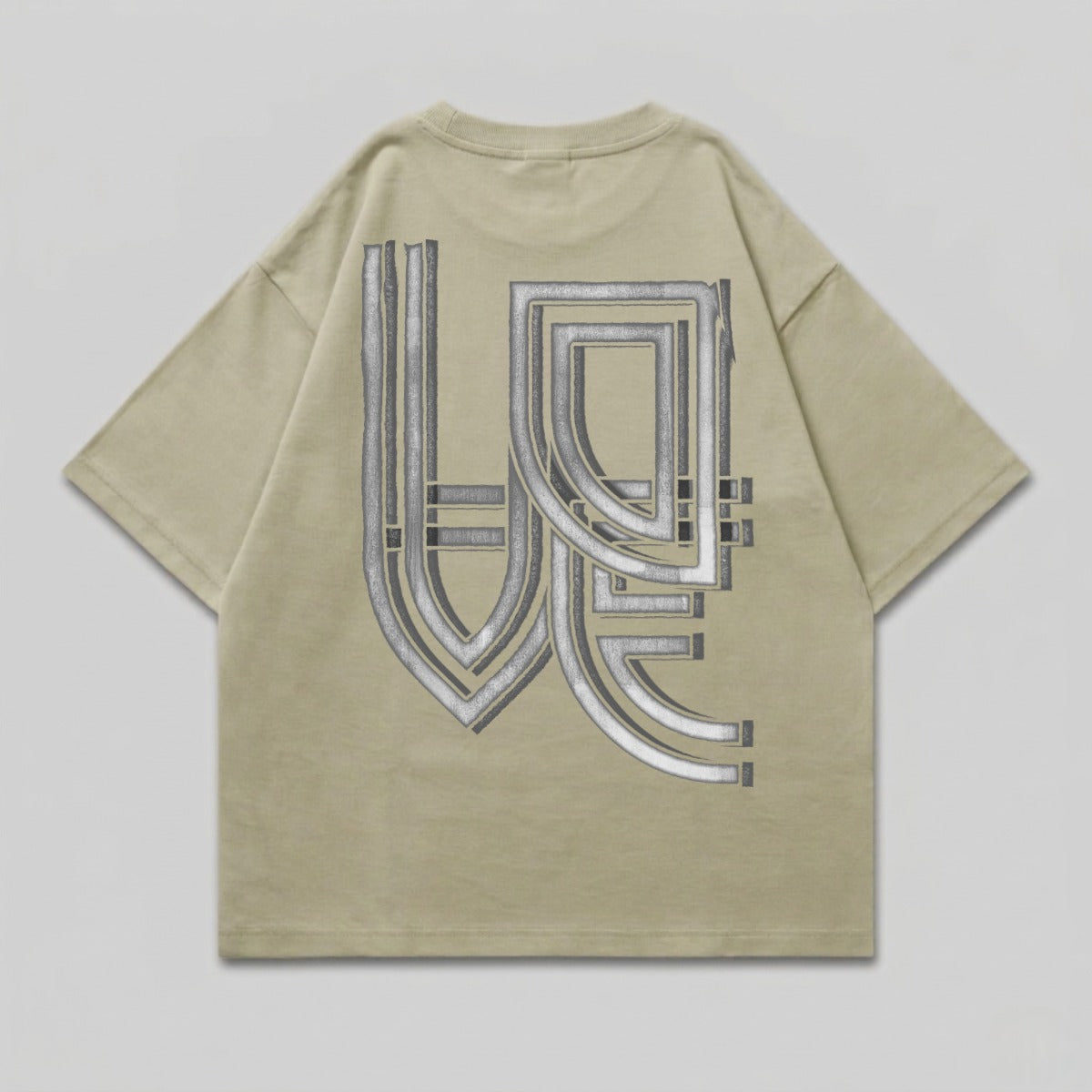 Oversized tan t-shirt with a large, metallic geometric graphic on the back.