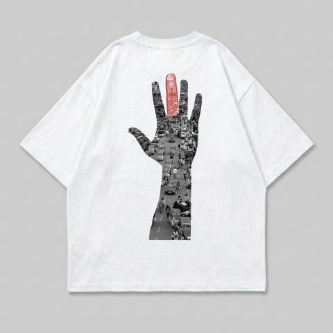 White t-shirt with black and red hand graphic of busy street scene.