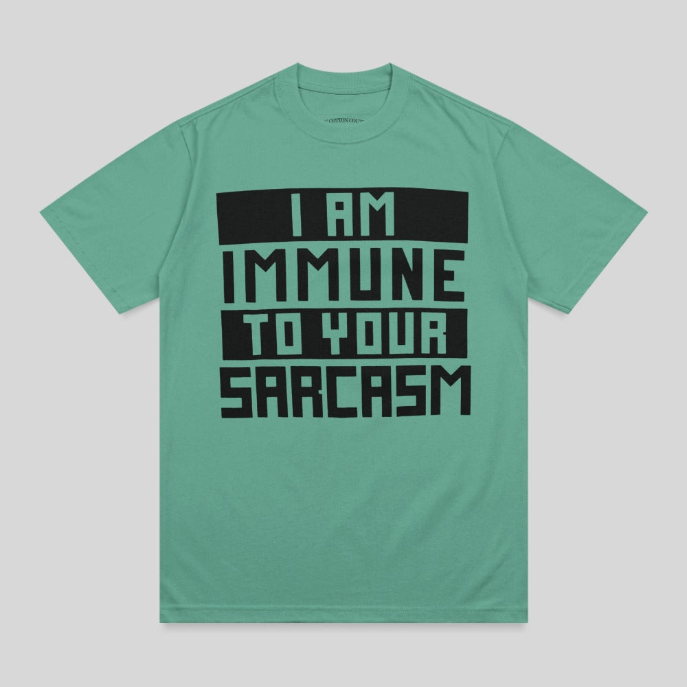 Teal t-shirt with black text reading "I AM IMMUNE TO YOUR SARCASTIC".