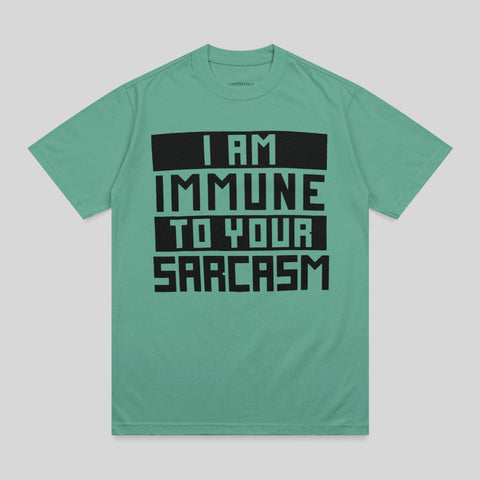 Teal t-shirt with black text reading "I AM IMMUNE TO YOUR SARCASTIC".