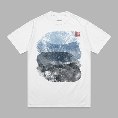 White t-shirt with abstract watercolor brushstrokes in blue, gray, and black.