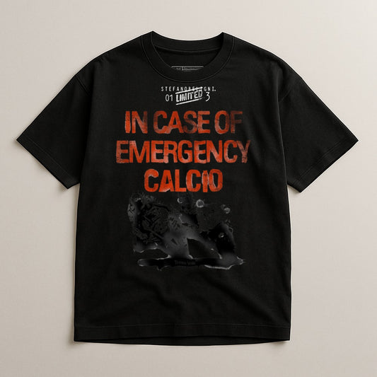Black t-shirt with "IN CASE OF EMERGENCY CALCIO" in red text.