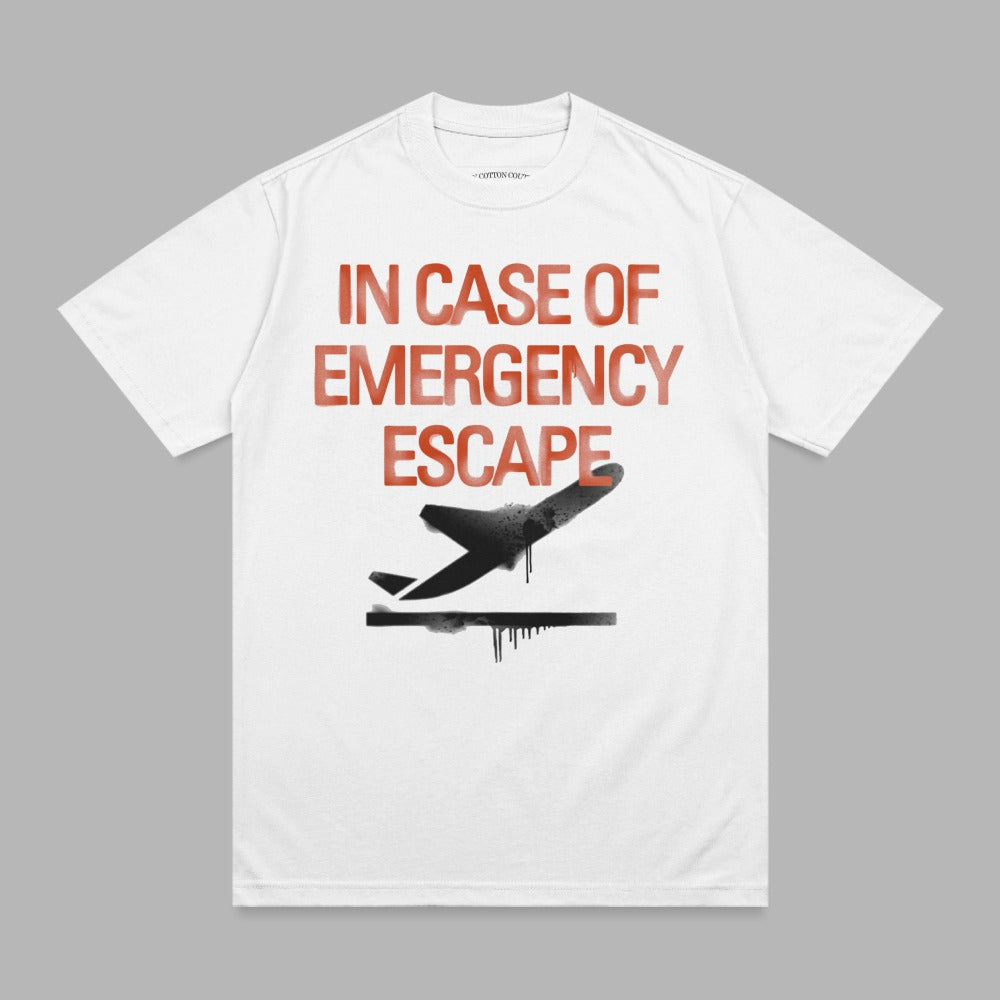 White t-shirt with red graphic: "IN CASE OF EMERGENCY ESCAPE" and a black airplane silhouette.