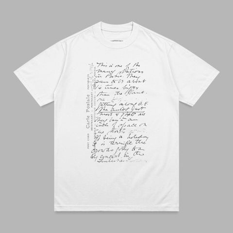 White t-shirt with handwritten script text and postal markings.