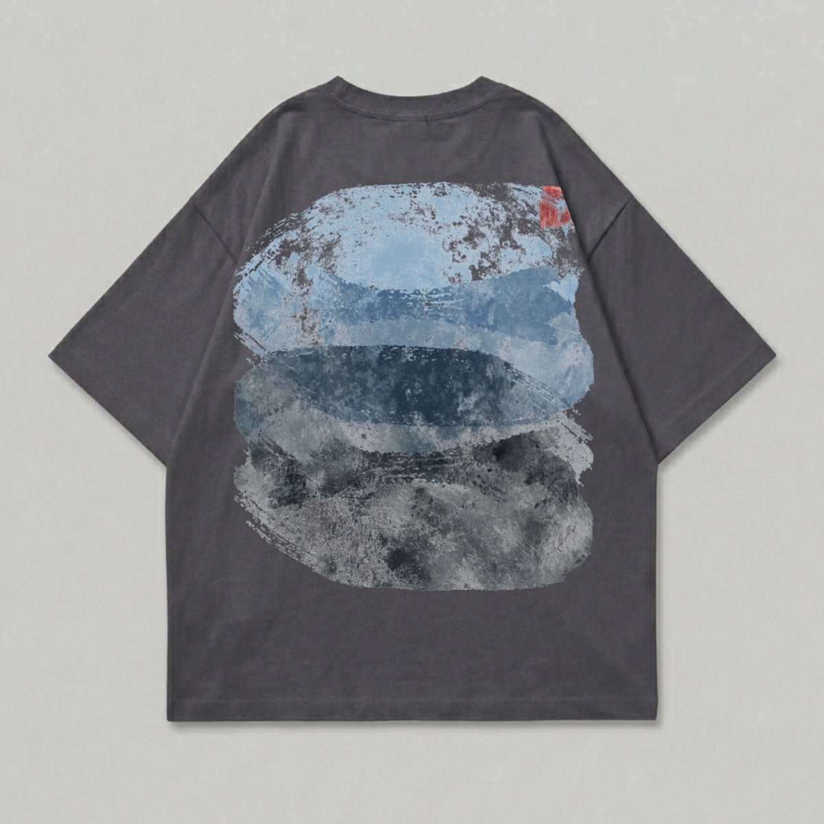 Dark grey t-shirt with abstract blue and grey brushstroke design on back.