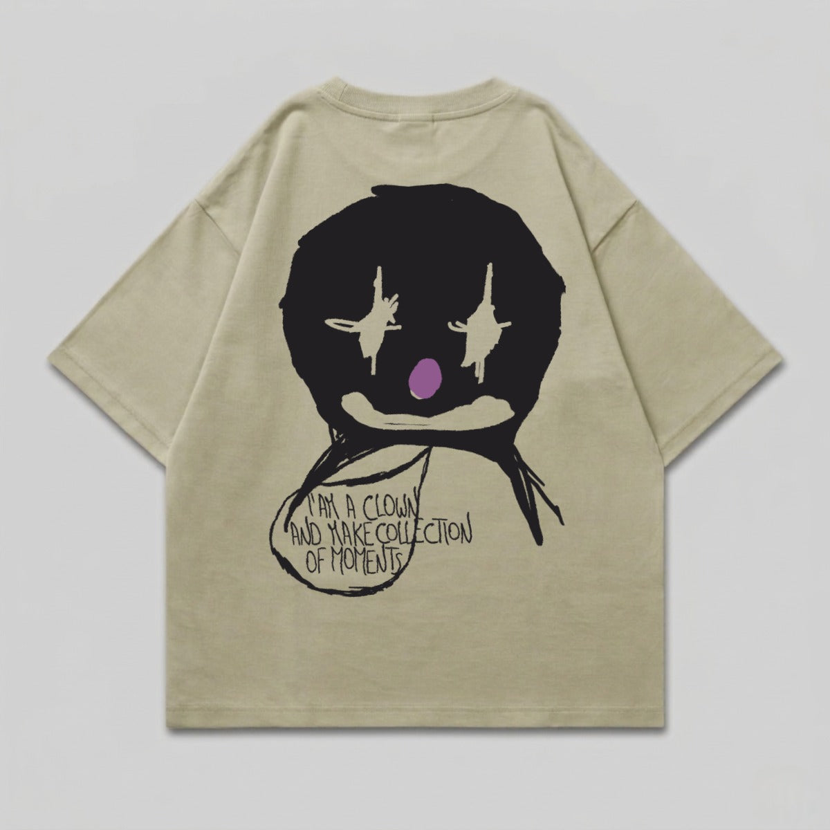 Tan t-shirt with black clown face graphic and text.
