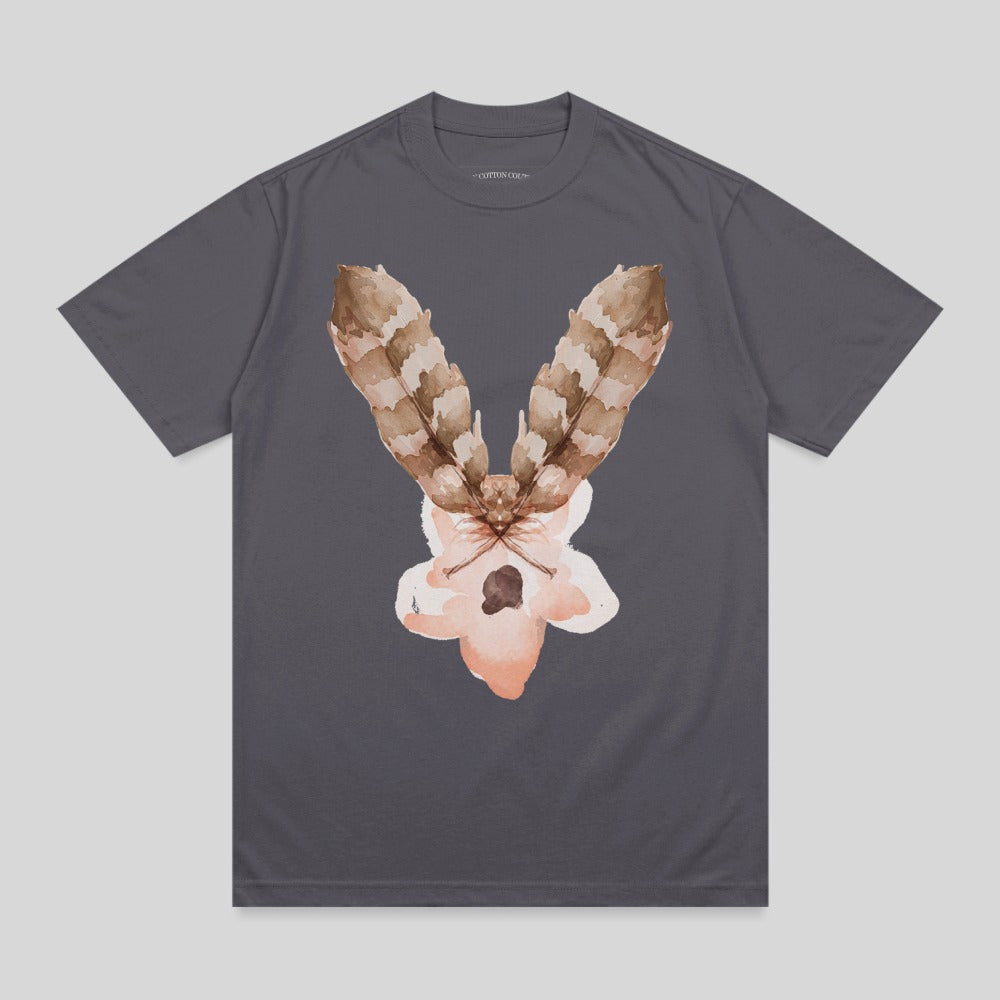 T-shirt with a watercolor moth design featuring feather-like wings and a pale pink body.
