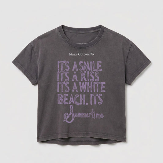 Dark grey t-shirt with "Mary Cotton Co." and purple text "IT'S A SMILE IT'S A KISS IT'S A WHITE BEACH. ITS Summertime".