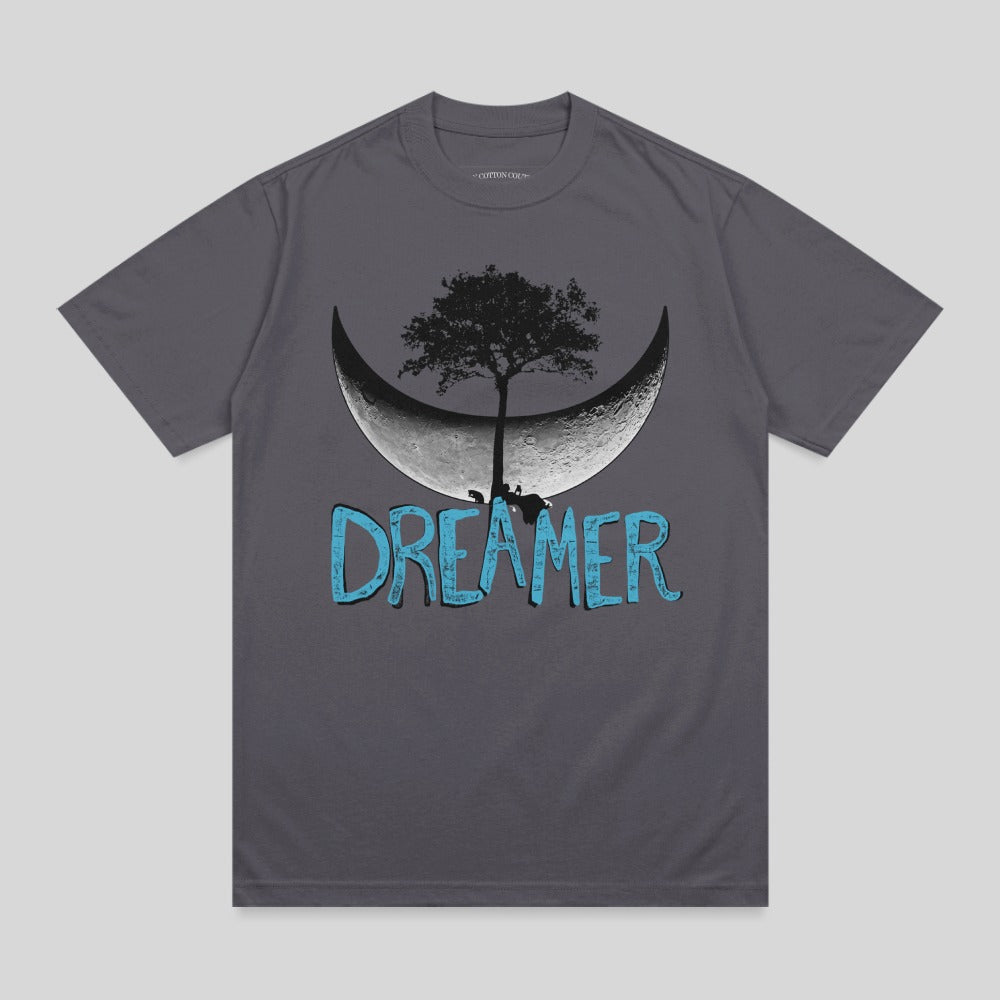 Dark grey t-shirt with a stylized crescent moon, tree, and "DREAMER" text.