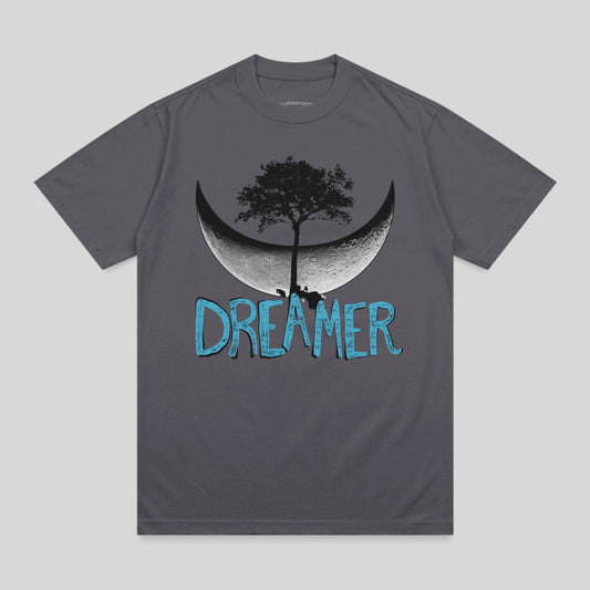 Dark grey t-shirt with a stylized crescent moon, tree, and "DREAMER" text.