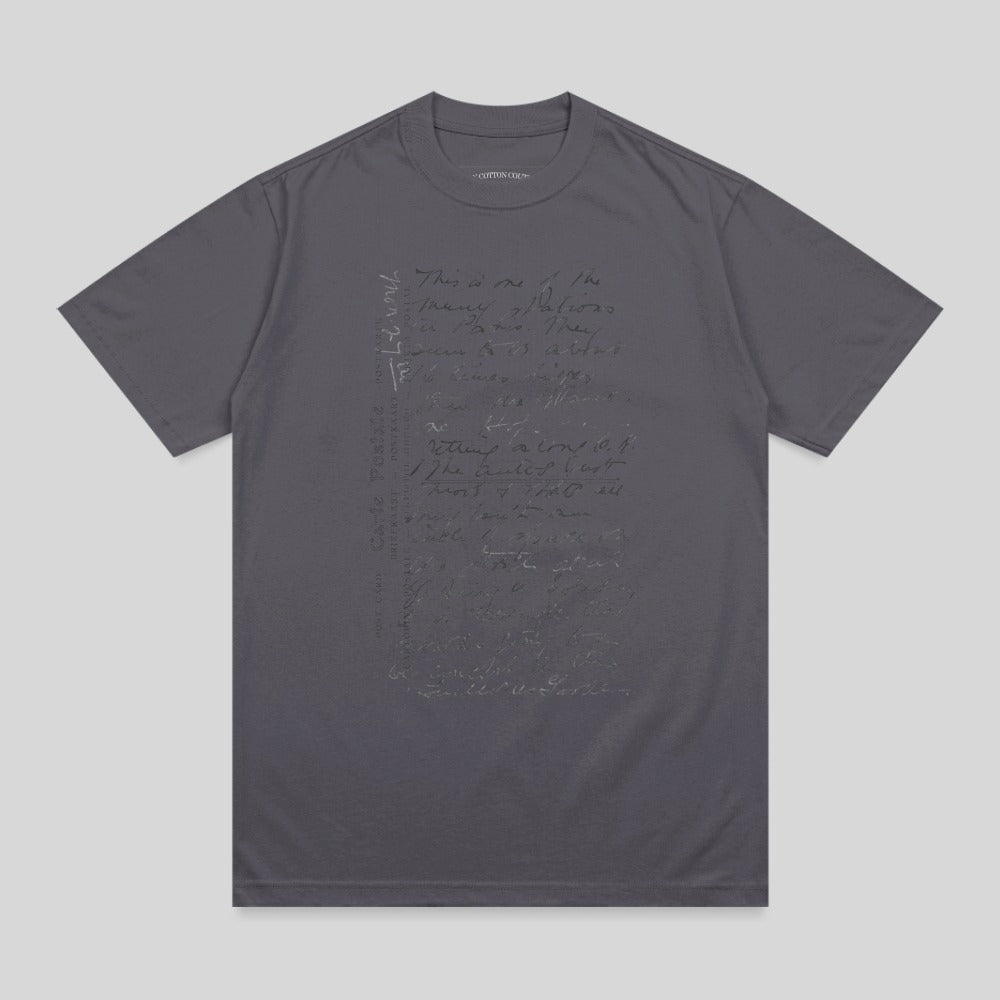 Charcoal t-shirt with handwritten text in a muted tone.
