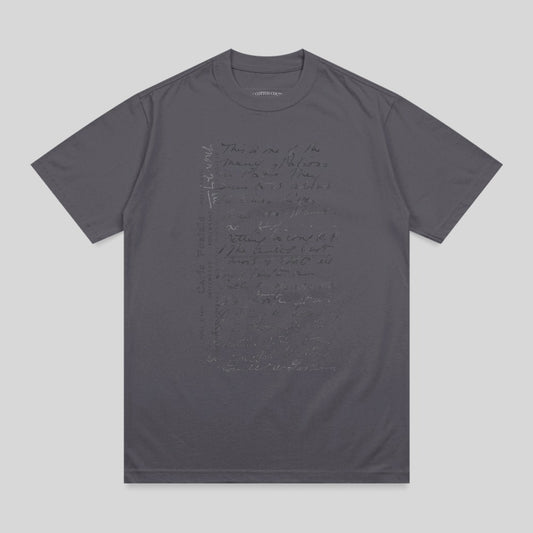 Charcoal t-shirt with handwritten text in a muted tone.