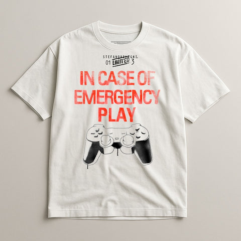 White t-shirt with "IN CASE OF EMERGENCY PLAY" and a sketched video game controller.