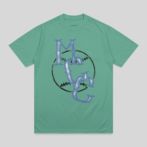 Green t-shirt with a large blue "MC" logo inside a black baseball circle.