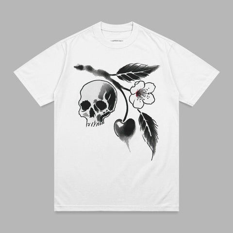 White t-shirt with a black ink illustration of a skull and cherry branch.