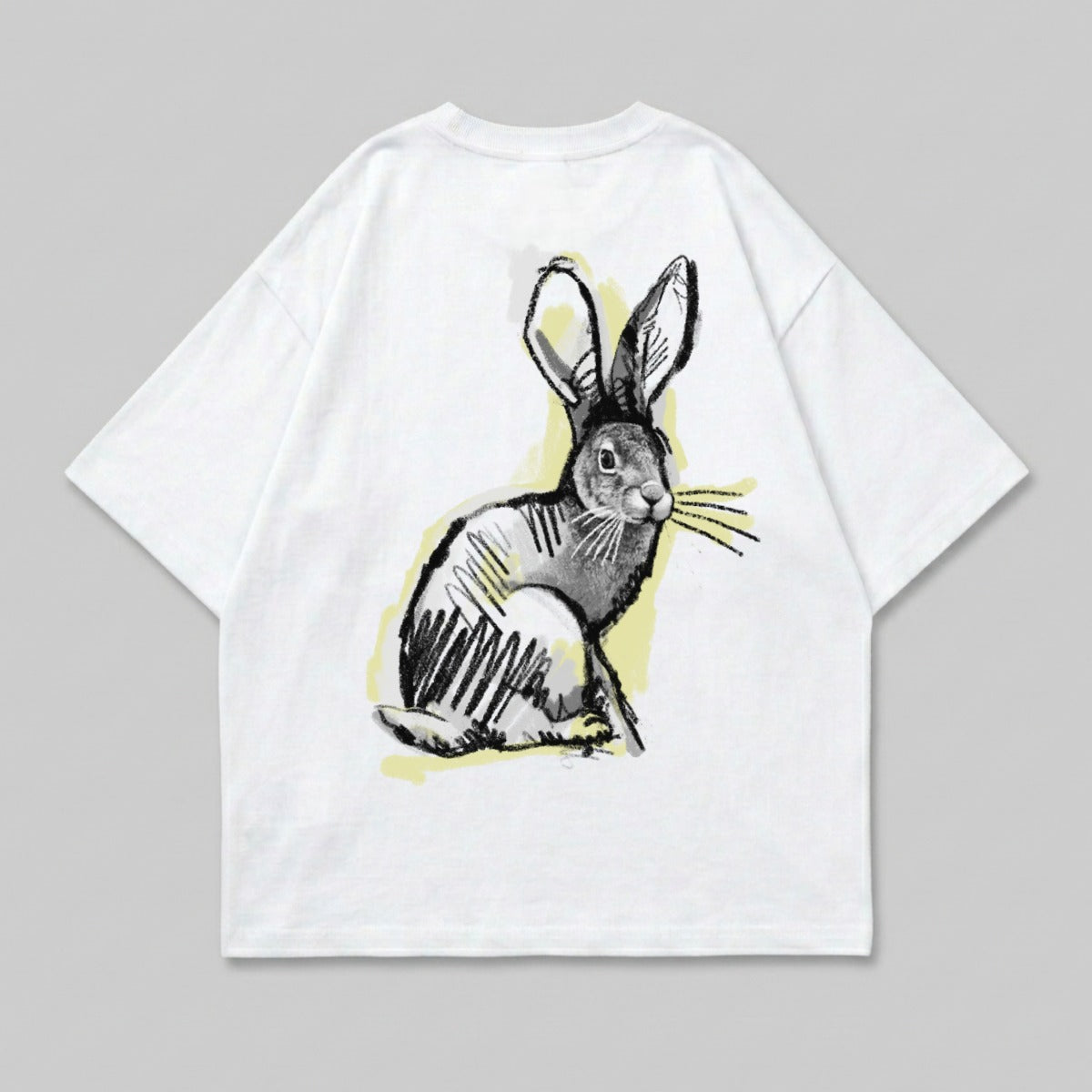 White t-shirt with a sketched rabbit graphic in black and yellow.