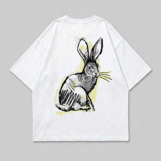 White t-shirt with a sketched rabbit graphic in black and yellow.