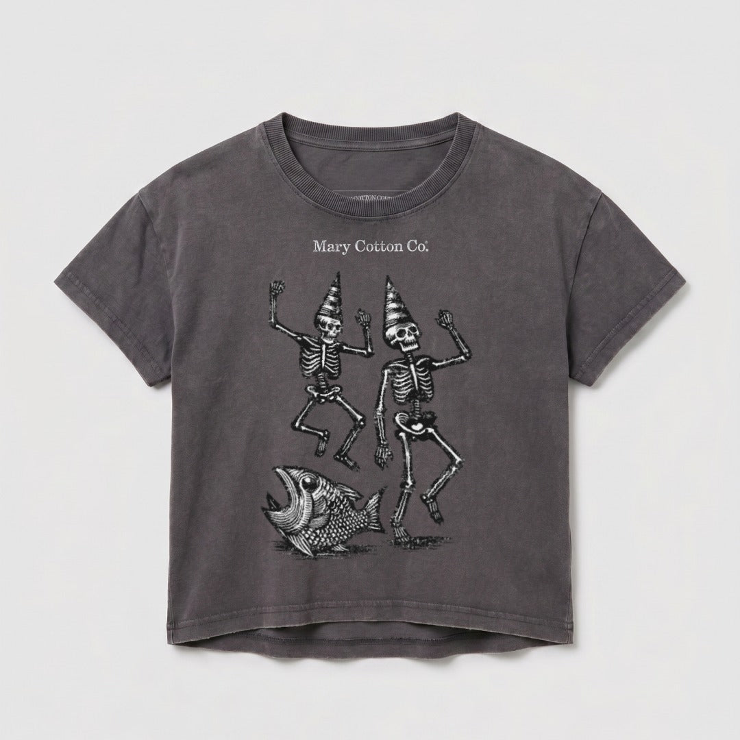 T-shirt with two dancing skeletons wearing party hats and a fish illustration.