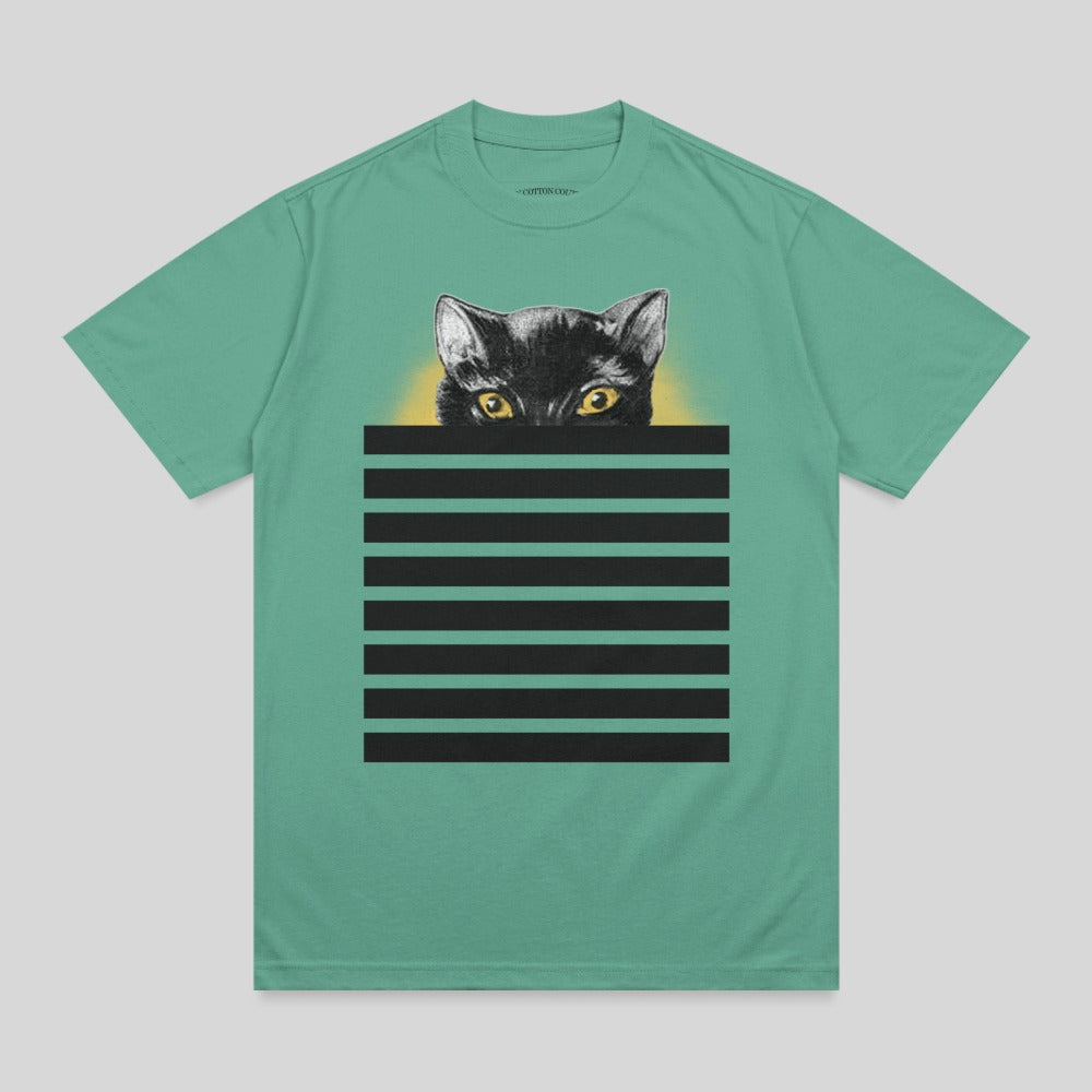 Black cat with yellow eyes peeking over black stripes on a teal t-shirt.