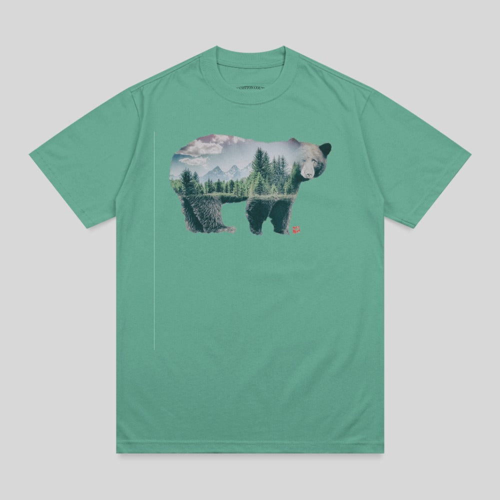Bear silhouette filled with forest landscape and mountains.