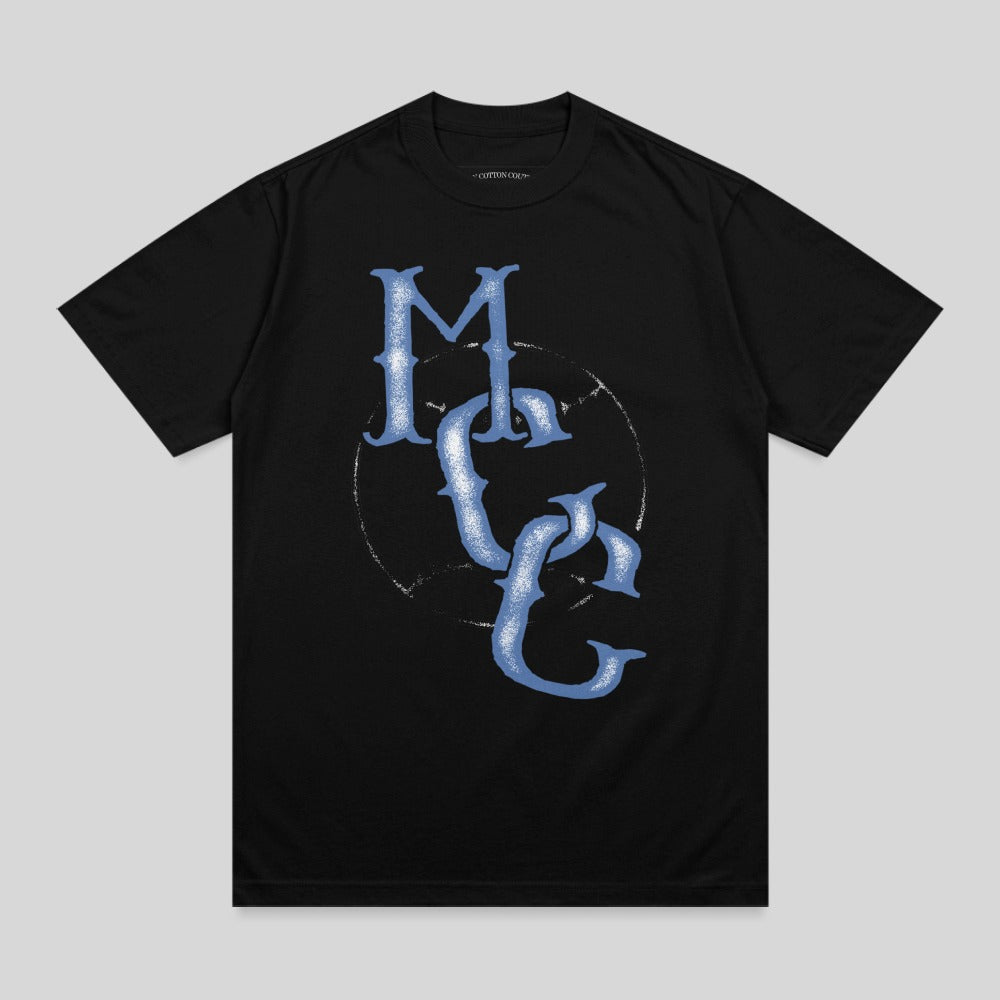 Black t-shirt with distressed blue "MC" logo in a circle.