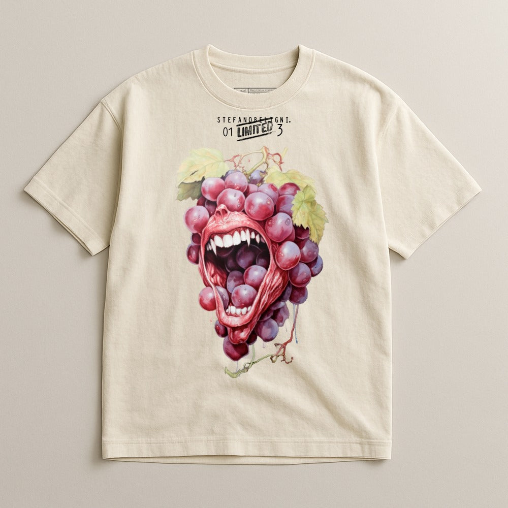 Cream t-shirt with graphic of open mouth with grape teeth.