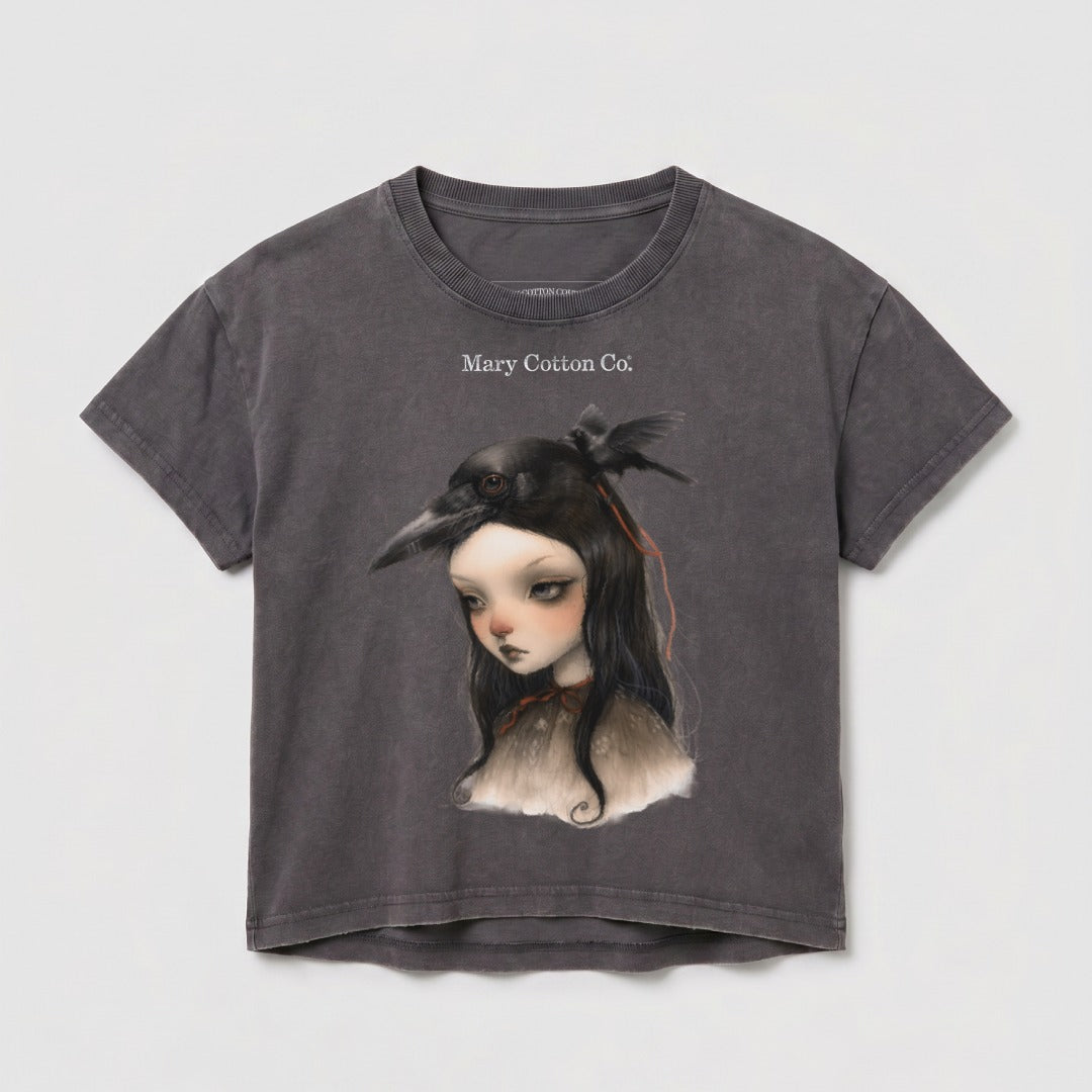 Dark gray t-shirt with a girl wearing a bird mask and Mary Cotton Co. logo.